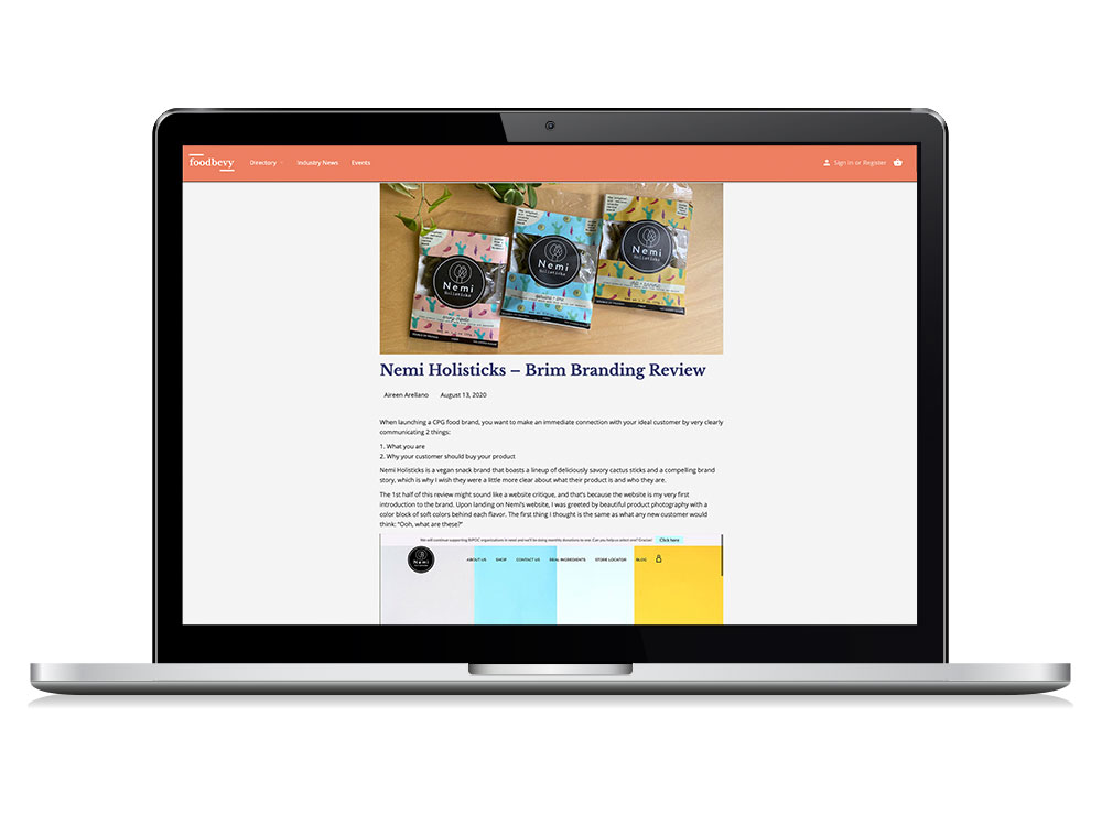 A laptop that shows a screenshot of "Nemi Holisticks - Brim Branding Review" on Foodbevy.com.